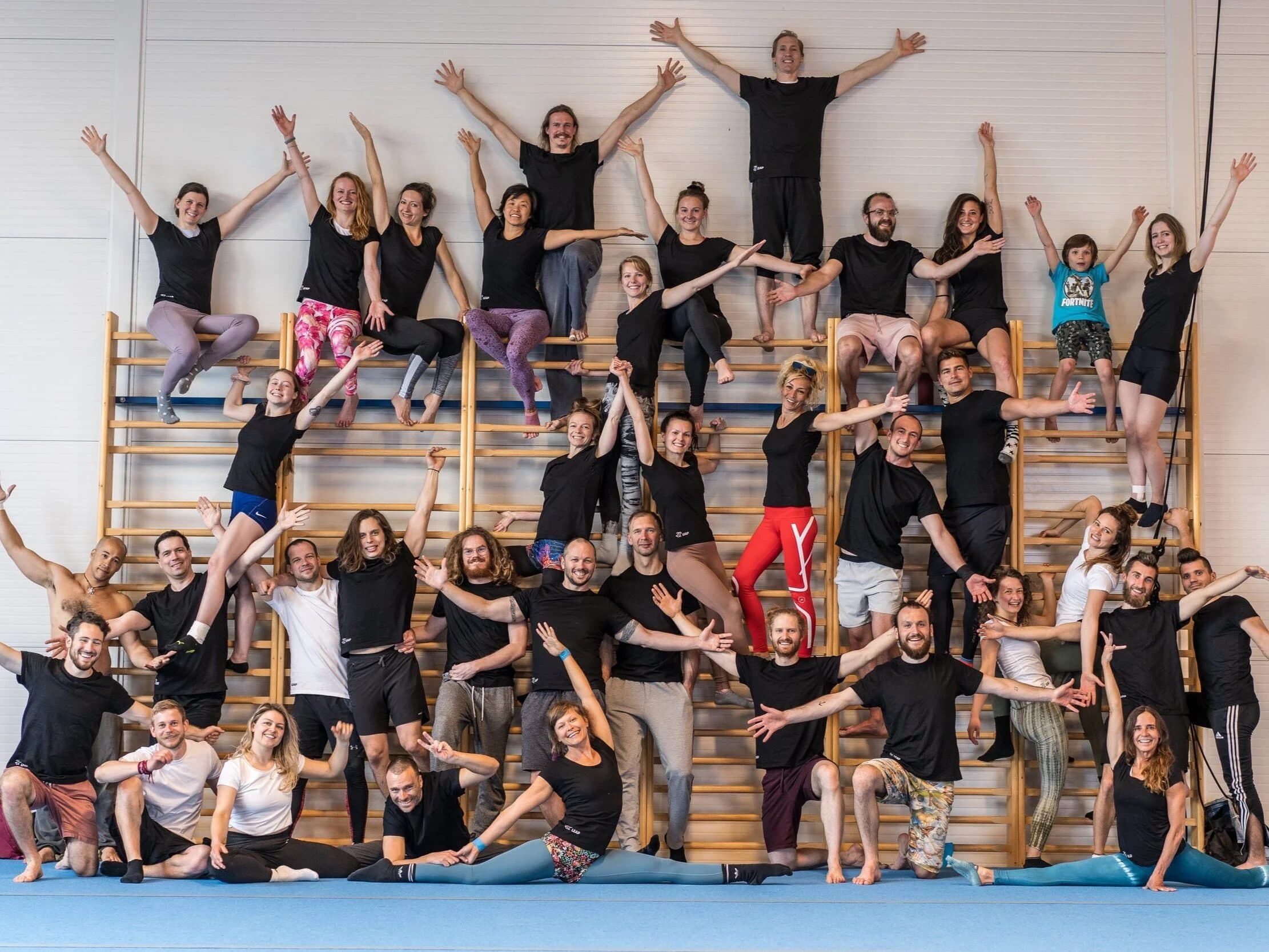 The LEAP group at the wall bars of Jojo Gym, arms up