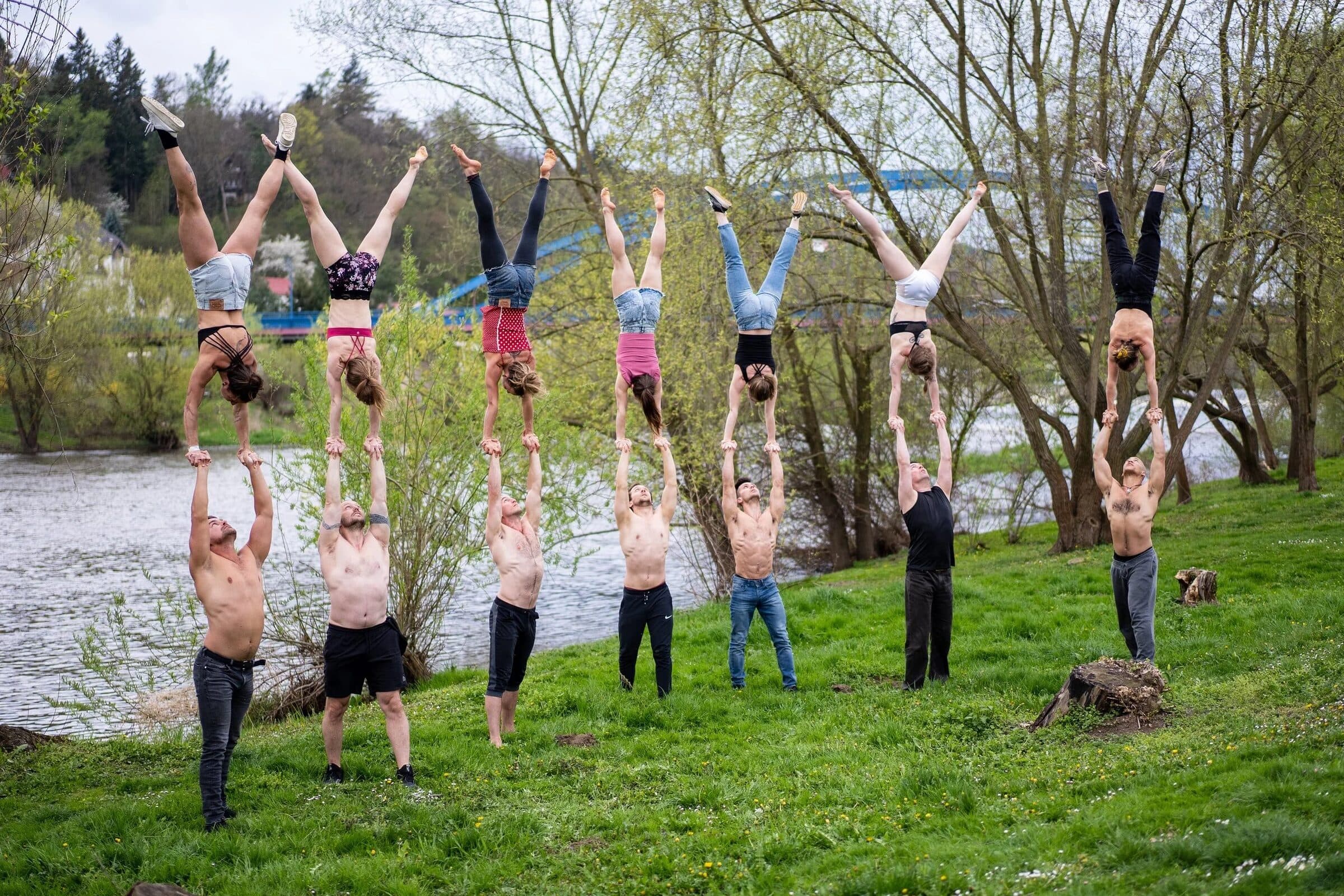 A row of pairs in hand to hand on the riverbank